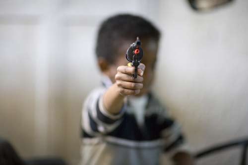 Jeruslem kid pointing toy gun at camera