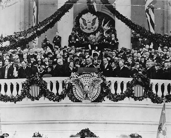 Chief Justice Charles Evans Hughes administering oath of office to Franklin Delano Roosevelt on the east portico of the U.S. Capitol, March 4, 1933