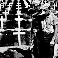Soldiers salute at grave