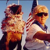 Dog and woman in flags on motorcycle