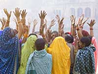 Hindu women singing and praying by river in India