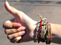 Woman's hand, thumbs up, hitching a ride