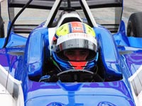 Driver in an open-wheel, open-cockpit Champ Car.