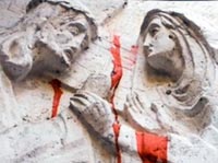 Jesus and Mary with red paint, sculptural relief on a Jerusalem building, photo by Jake Warga