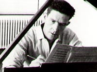 John Cage composing at piano