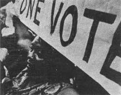 Woman with sign: One Person, One Vote