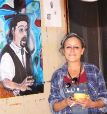 Tasha Robbins standing by her painting of Dave Bronks