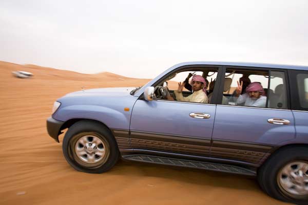 Dune bashing in Dubai, Arabs in SUV riding in desert