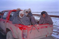 Northern Alliance soldiers in Toyota pickup driving the road from Mazur to Shrerbigan