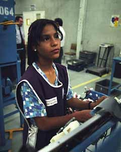 An adolescent Mexican girl works an American maquiladora factory.