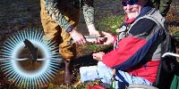 Former USMC Sgt Bill Johnson holds his just-caught trout