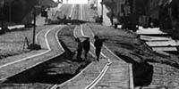 1906 photo of street and trolley tracks ripped by quake