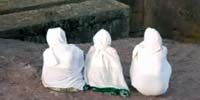 Three women in white robes