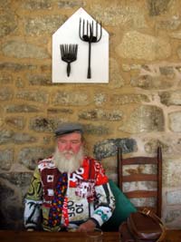 Bobby seated under his American Golthic artwork