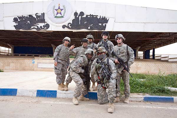 Troops posing outside the Palace bandstand Saddam from Palace Balcony